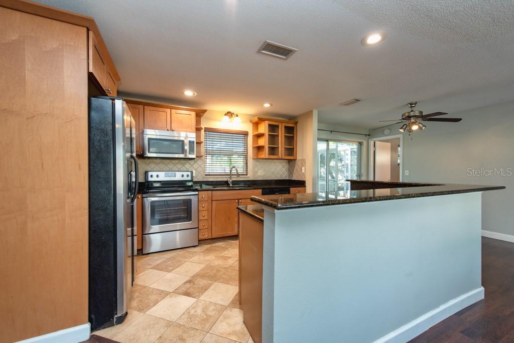 1877 Dawn Drive Clearwater, FL 33763 - Photo 8 of 36 a kitchen with stainless steel appliances a refrigerator sink and stove