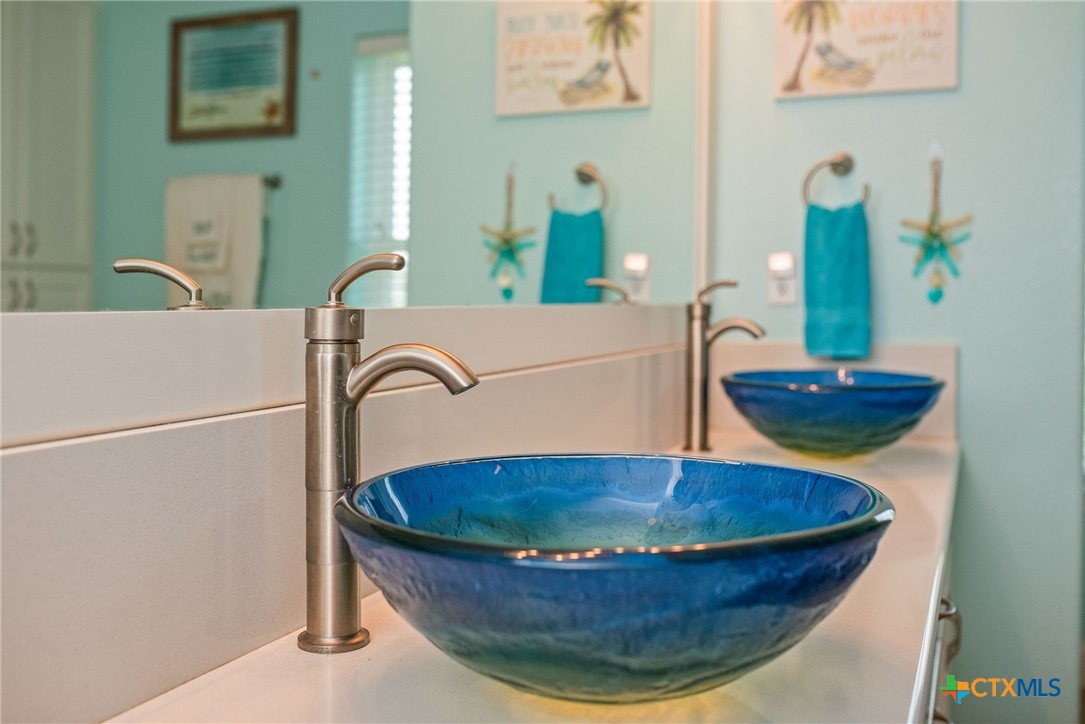 23 Macey Street Port O'Connor, TX 77982 - Photo 46 of 47 a bathroom with a sink and a mirror