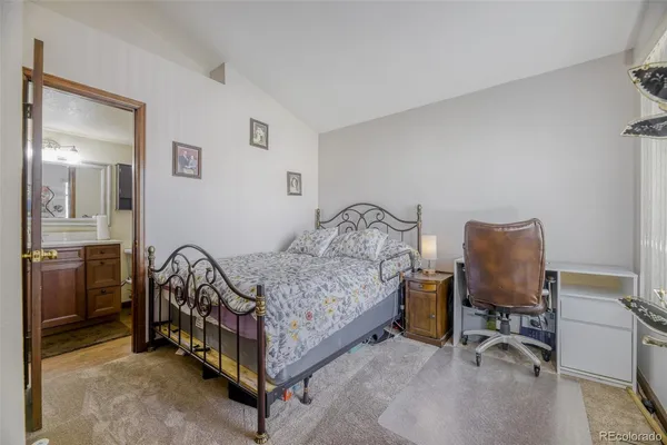 a bed room with a bed and a chair