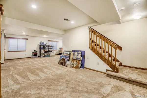 a view of a livingroom with furniture and stairs