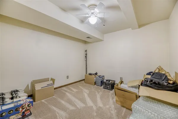 a room with gym equipment and a chandelier