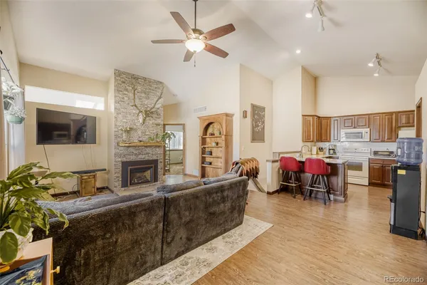 a living room with fireplace furniture and a flat screen tv