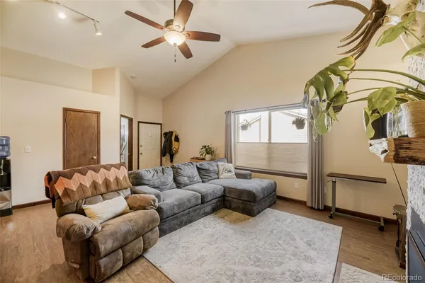 a living room with furniture ceiling fan and a rug