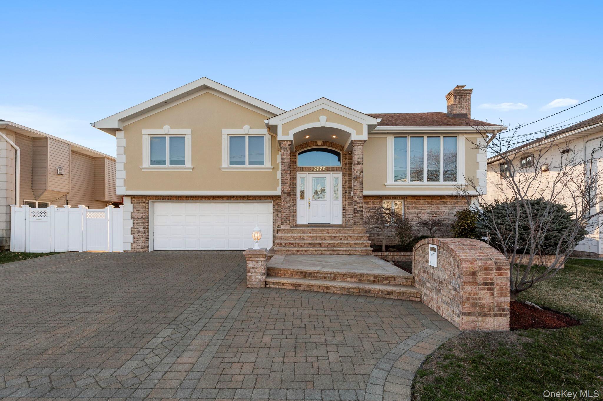 2770 Mandalay Beach Road Wantagh, NY 11793 - Photo 1 of 27 a front view of a house with garden