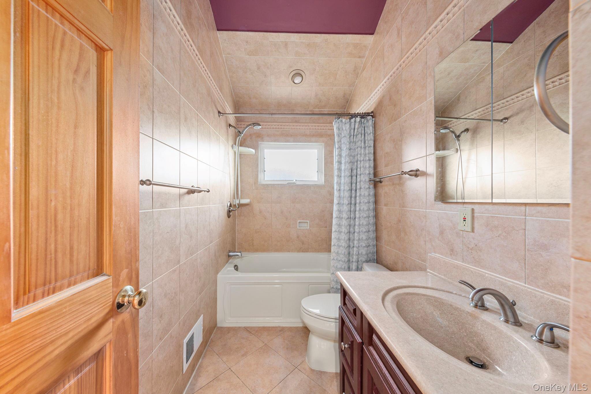 2770 Mandalay Beach Road Wantagh, NY 11793 - Photo 11 of 27 a bathroom with a sink a toilet and shower