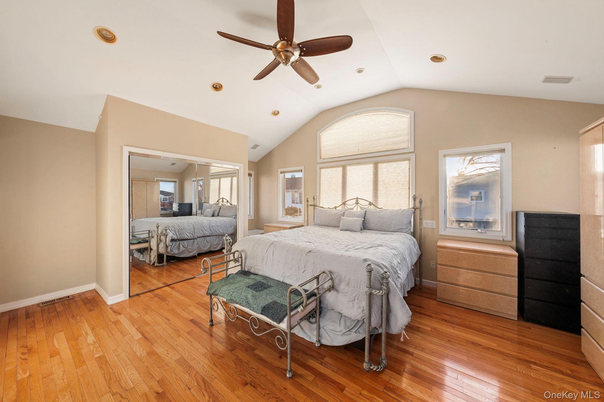 2770 Mandalay Beach Road Wantagh, NY 11793 - Photo 12 of 27 a spacious bedroom with a bed and a mirror