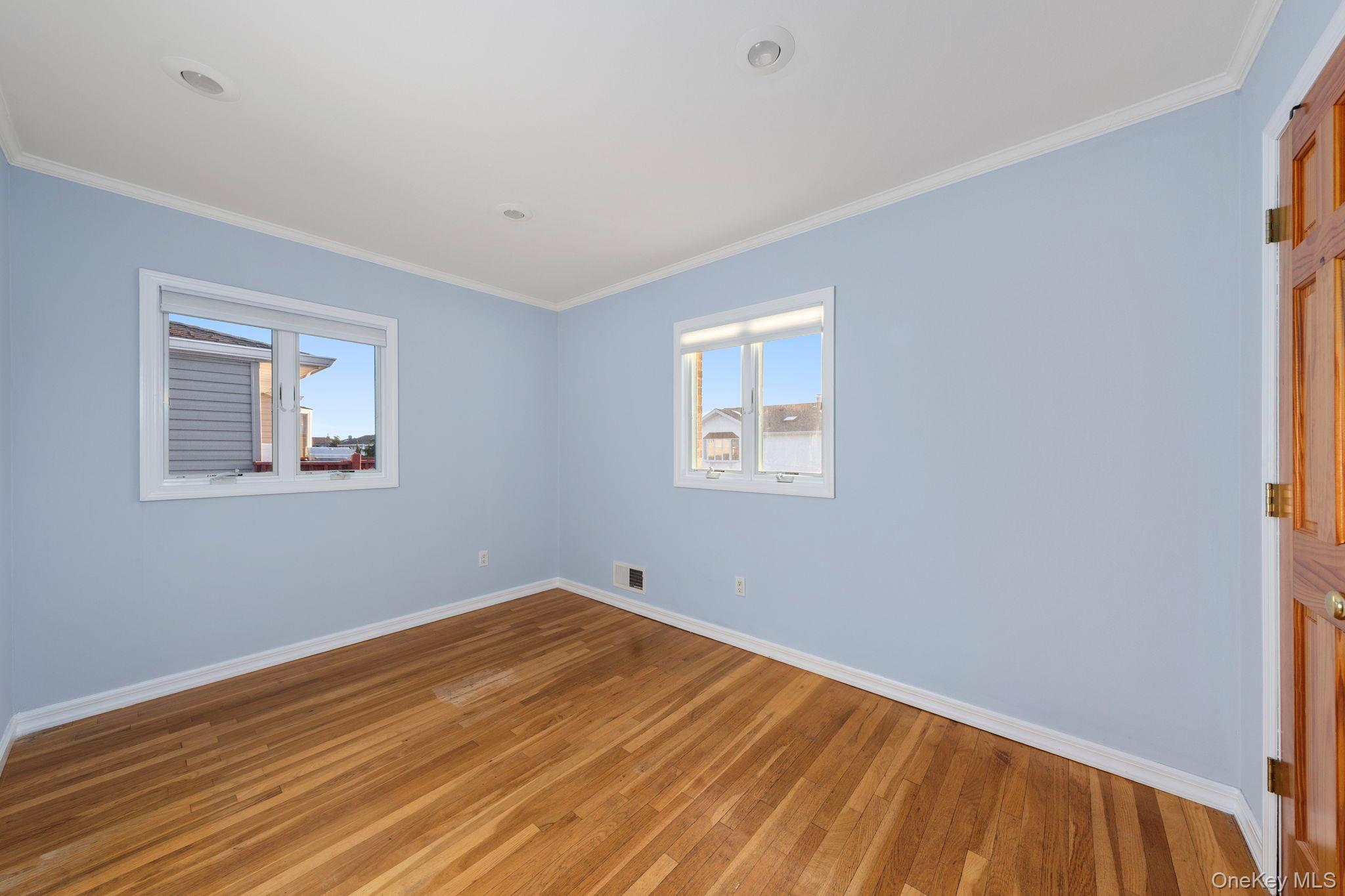 2770 Mandalay Beach Road Wantagh, NY 11793 - Photo 16 of 27 a view of empty room with wooden floor