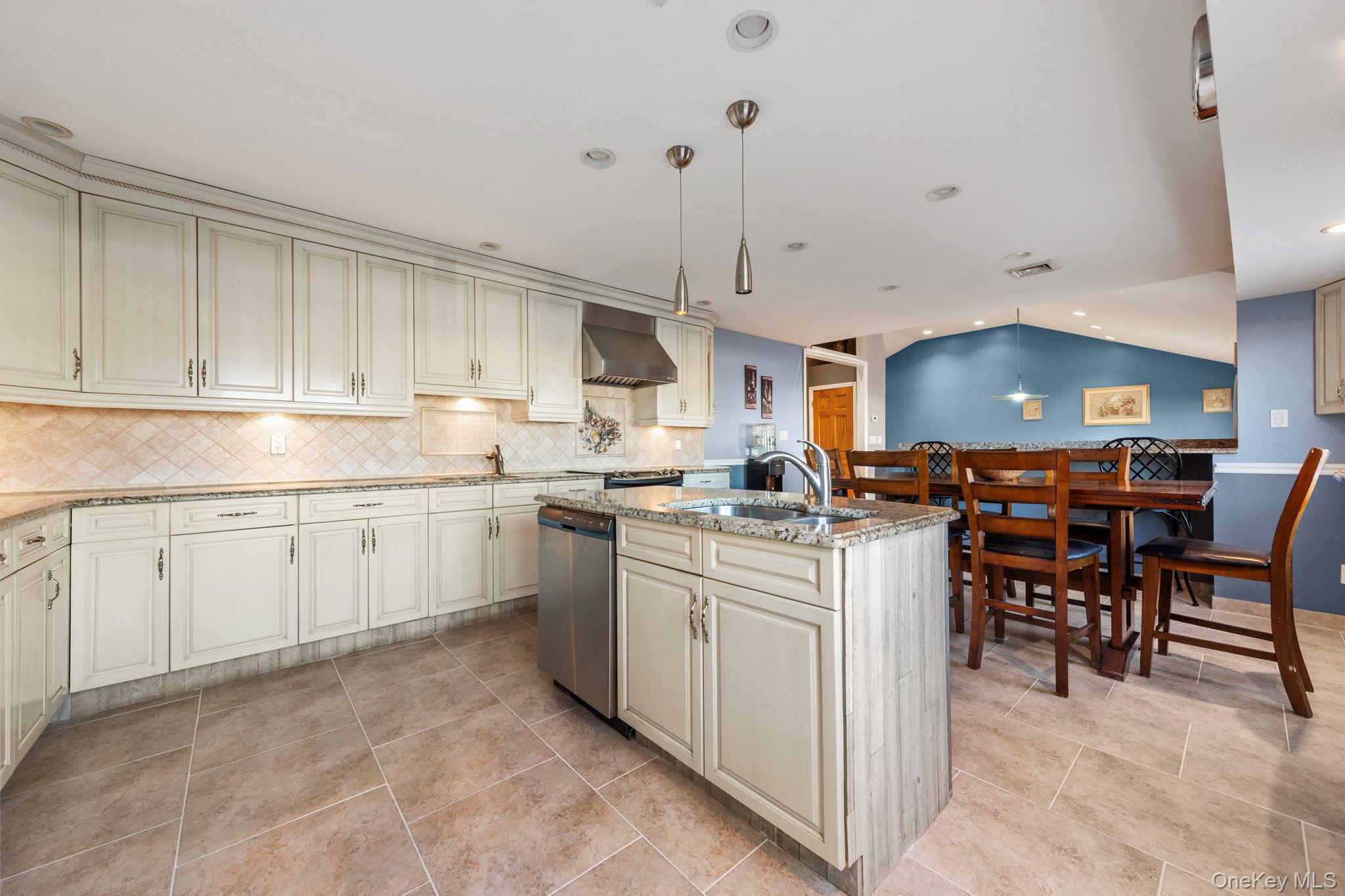 2770 Mandalay Beach Road Wantagh, NY 11793 - Photo 6 of 27 a kitchen with cabinets and chairs
