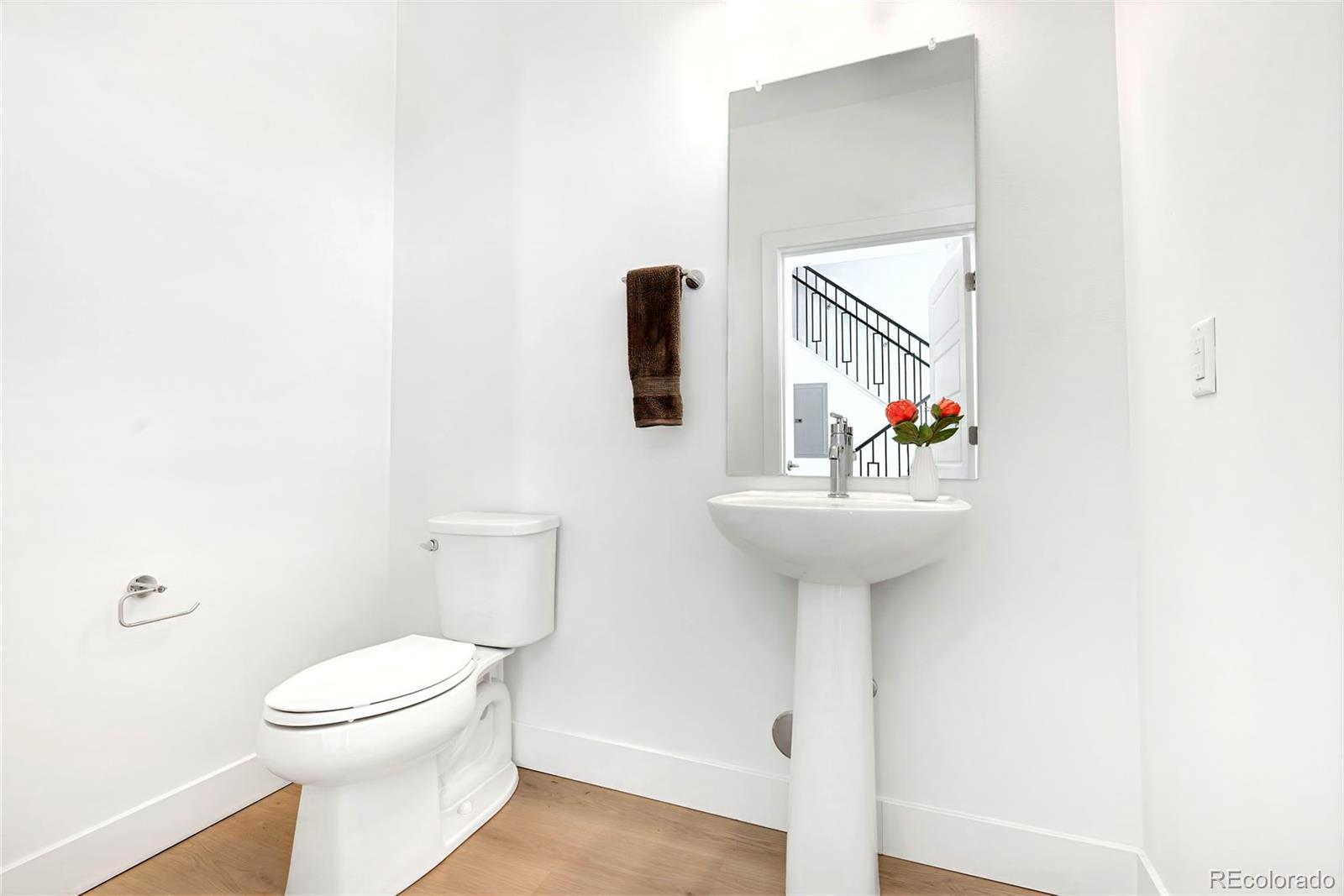 18 Oneida Court Denver, CO 80230 - Photo 4 of 4 a bathroom with a sink a toilet and mirror