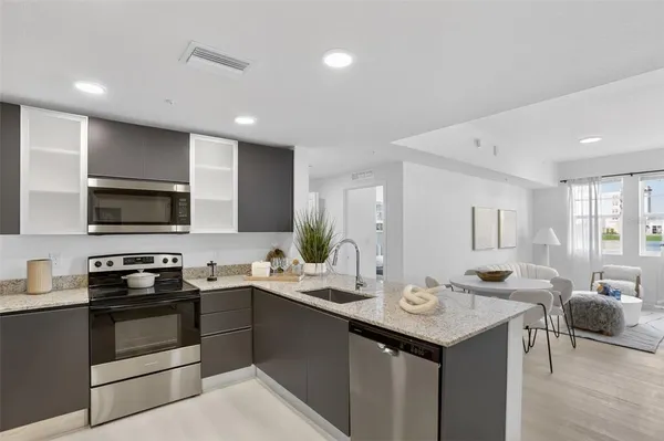 a kitchen with a sink stove and microwave
