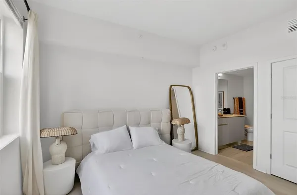 a bedroom with a bed and a bathroom