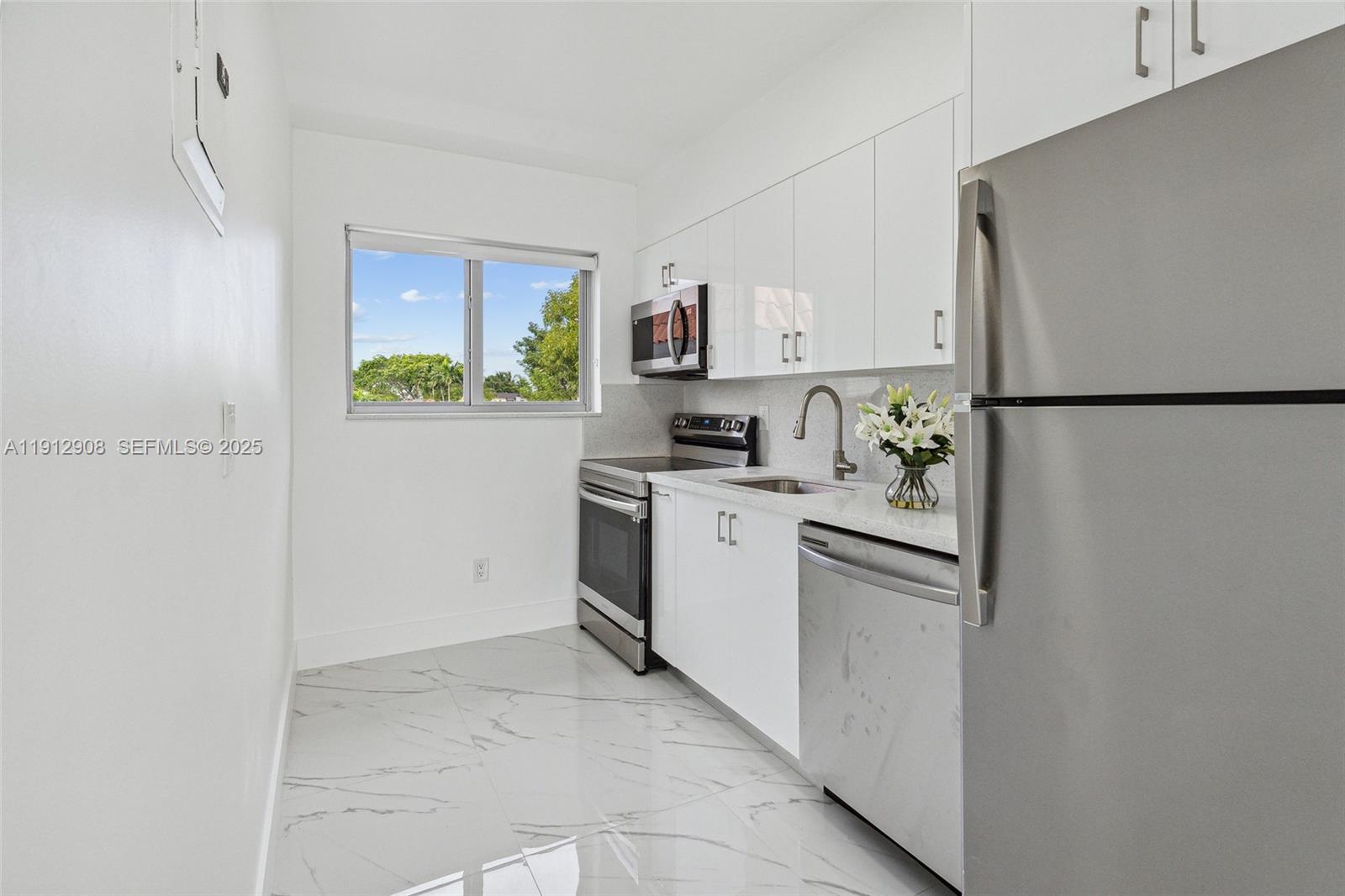 a kitchen with a refrigerator sink stove and cabinets