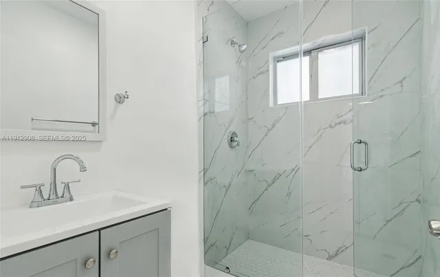 a bathroom with a shower sink and toilet