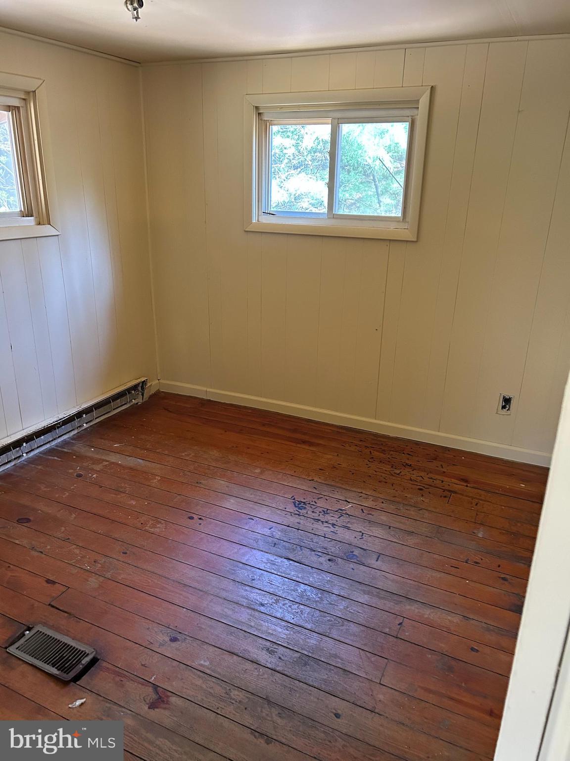923 Dever Hollow Road Millerstown, PA 17062 - Photo 7 of 12 a view of an empty room with wooden floor and a window