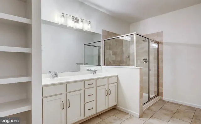 a bathroom with a double vanity sink and mirror