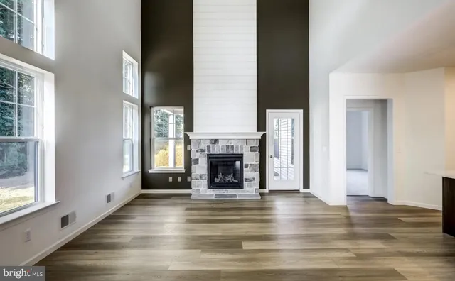 a view of an empty room with window and fire place