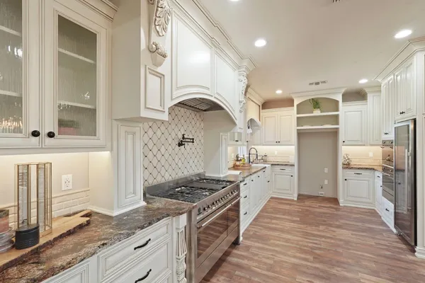 a kitchen with a stove a sink and a refrigerator