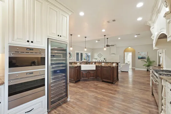 a kitchen with stainless steel appliances kitchen island wooden cabinets and granite counter tops