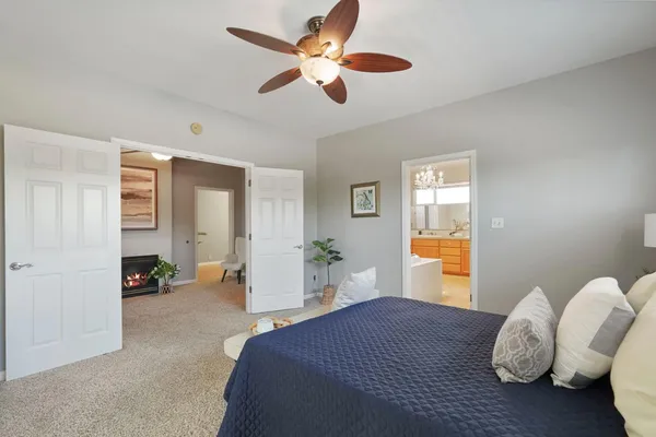 a bedroom with bed and a chandelier