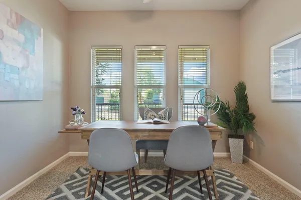 a dining room with furniture and window