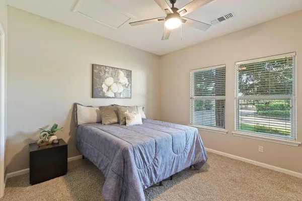 a bedroom with a large bed and a window