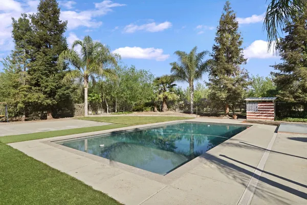 a view of a swimming pool with a yard