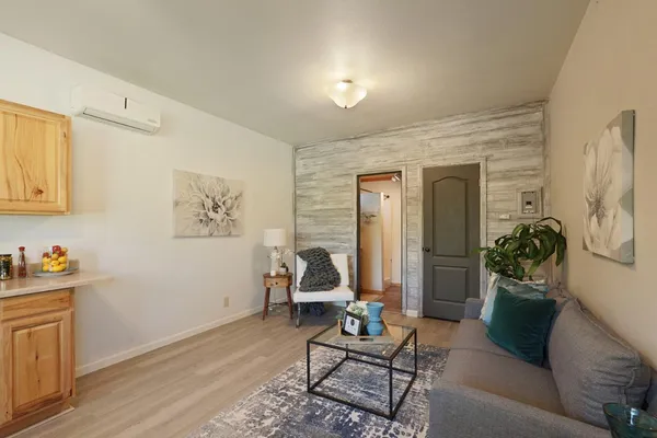 a living room with furniture and a wooden floor