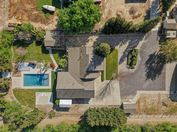 an aerial view of a house with a yard and potted plants