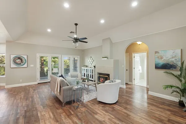 a living room with furniture and wooden floor