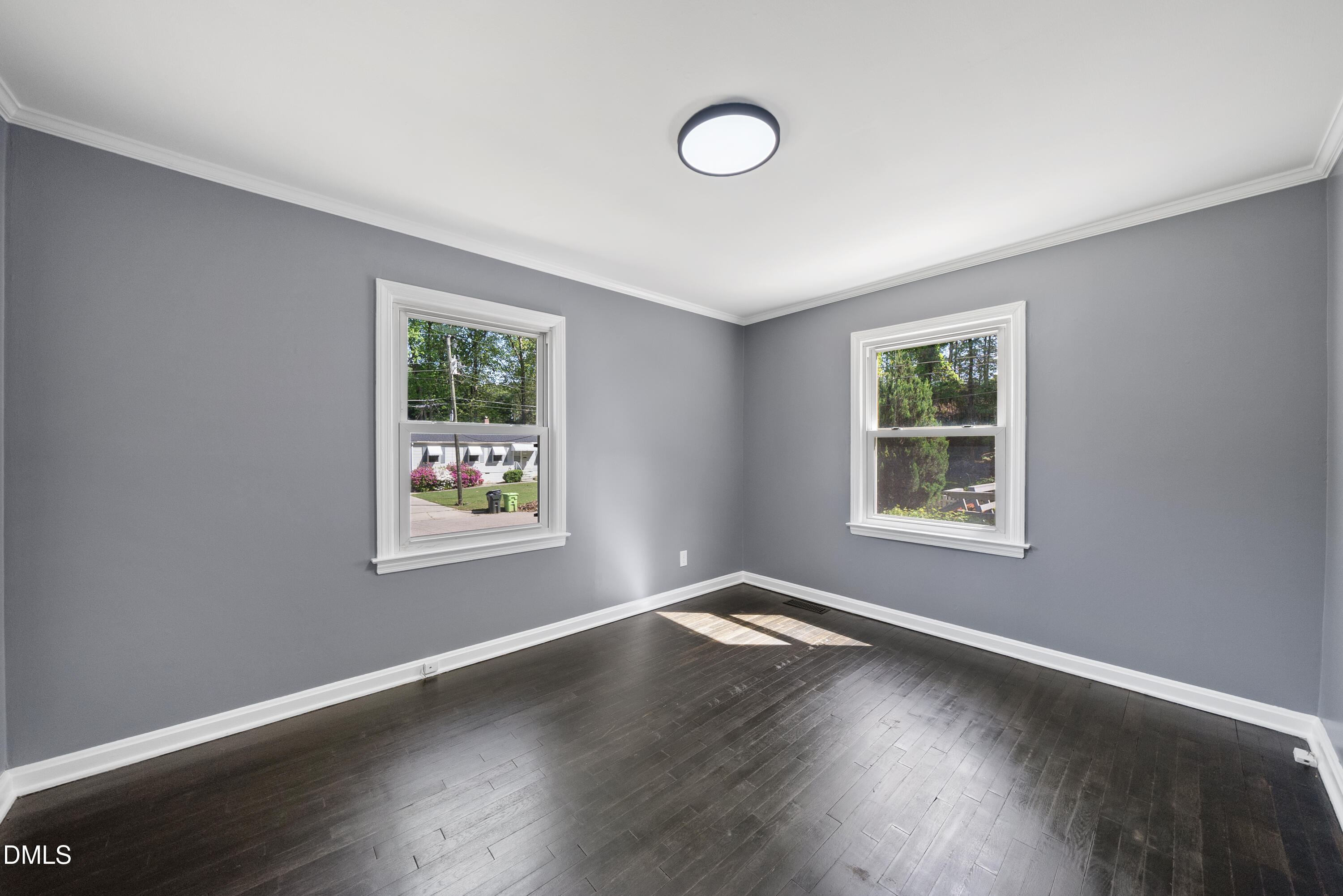 2810 Newbold Street Raleigh, NC 27603 - Photo 24 of 30 a view of an empty room with wooden floor and a window