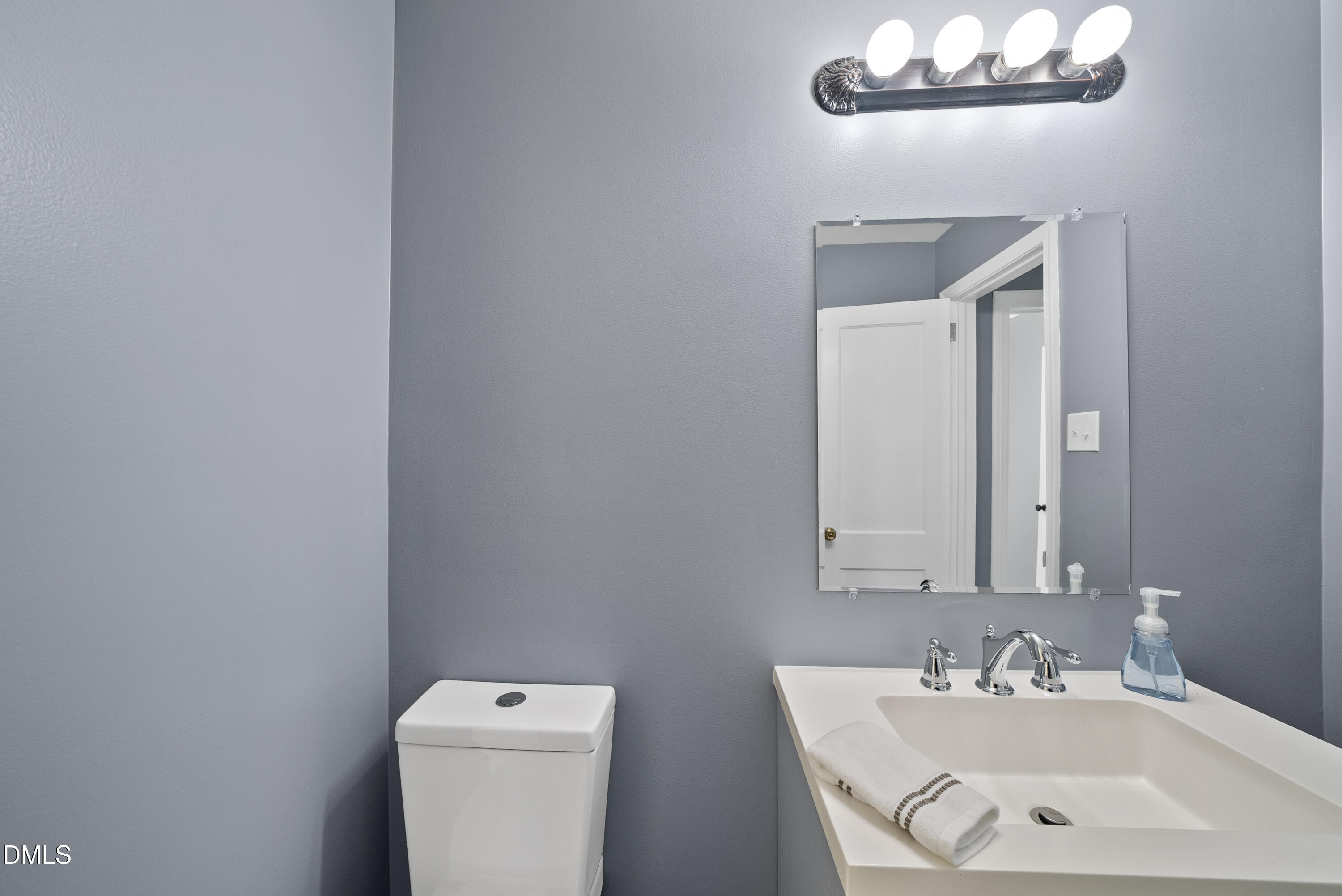 2810 Newbold Street Raleigh, NC 27603 - Photo 27 of 30 a bathroom with a sink a toilet and a mirror