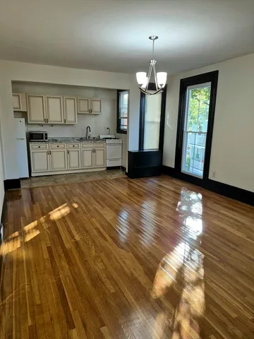 a view of a room with wooden floor and staircase