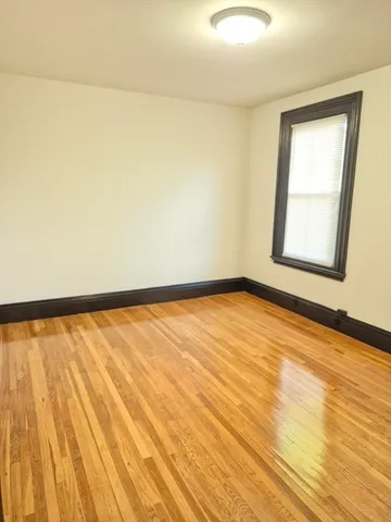 a view of an empty room and wooden floor