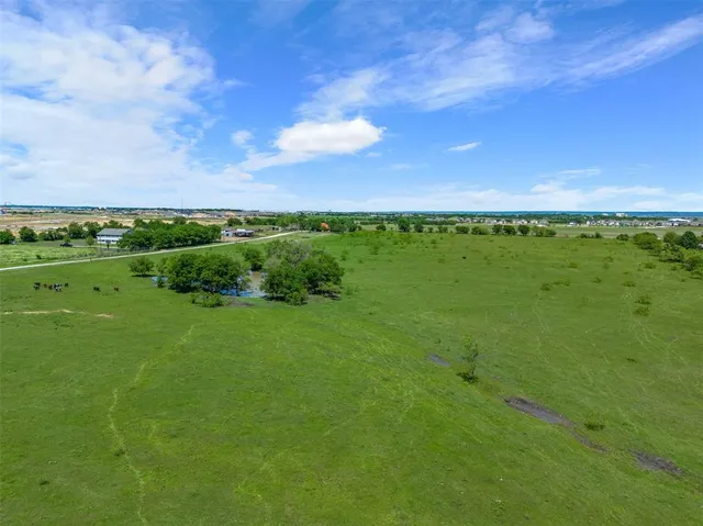 a view of a city with lush green forest