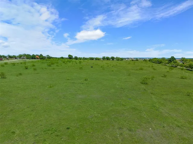 a view of a green field with clear sky