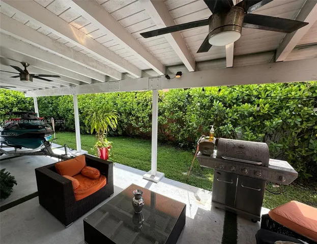 a view of a balcony with chairs potted plants