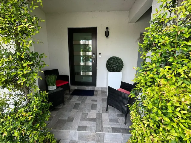 a kitchen with counter top space cabinets and chandelier