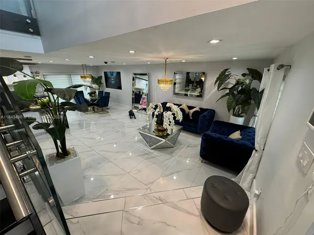 a kitchen with counter top space and living room view