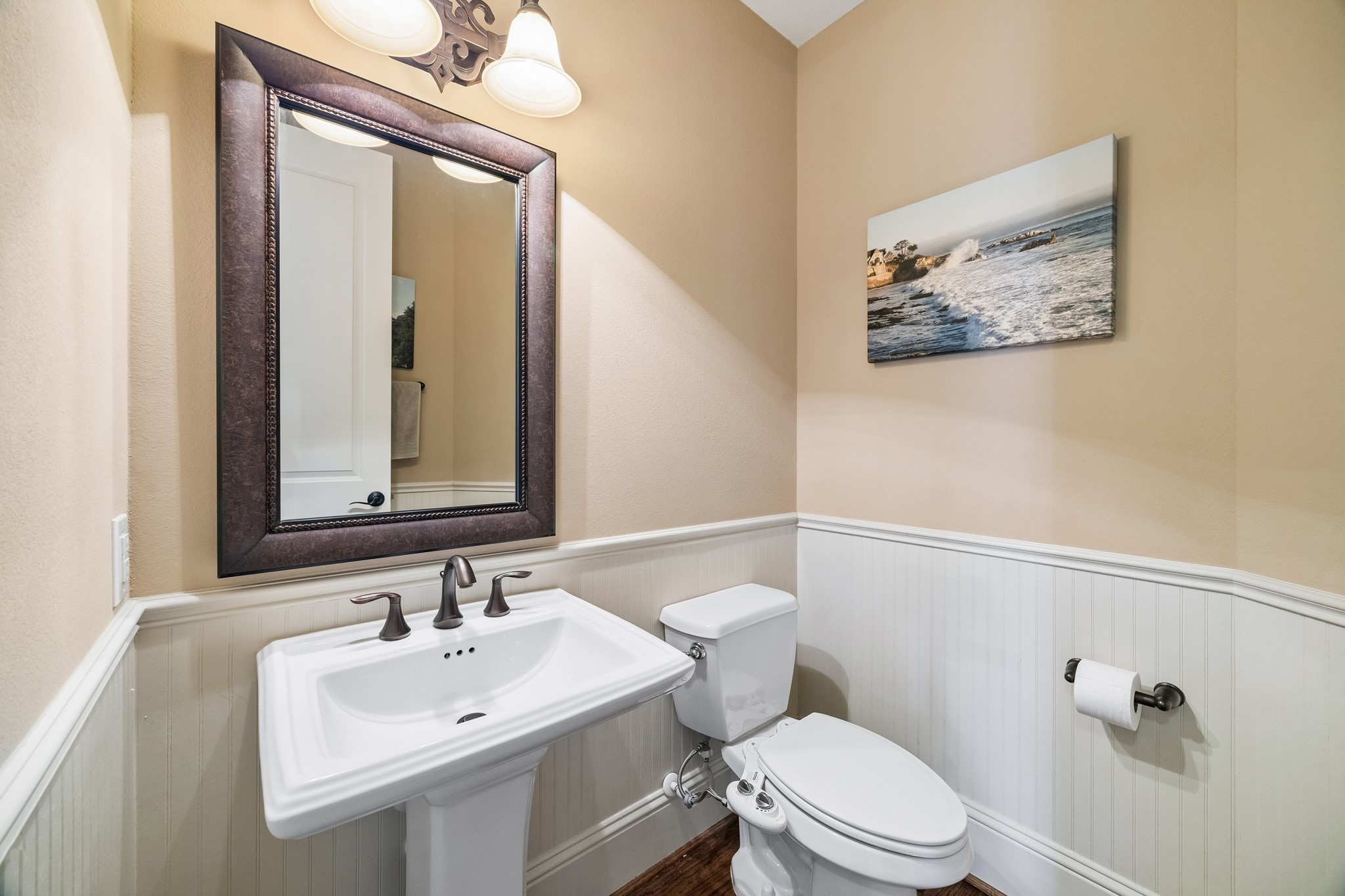 1360 Chippendale Road Houston, TX 77018 - Photo 31 of 34 Conveniently located powder bath situated between the family room and first-floor flex space. Features classic wainscoting, pedestal sink, oversized mirror, and timeless finishes that complement the home's elegant design.