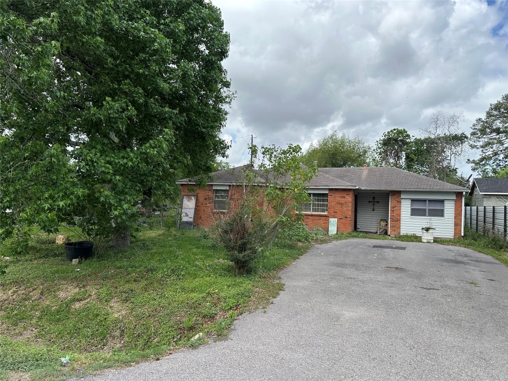 1001 Red Bud Street Channelview, TX 77530 - Photo 2 of 21 a front view of a house with a garden