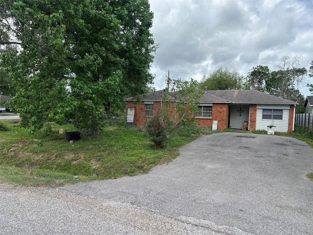 1001 Red Bud Street Channelview, TX 77530 - Photo 3 of 21 a view of a house with a yard and large tree