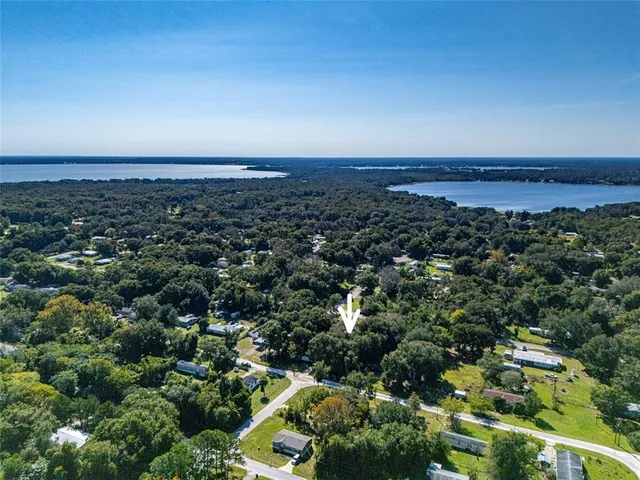 an aerial view of a houses with a yard