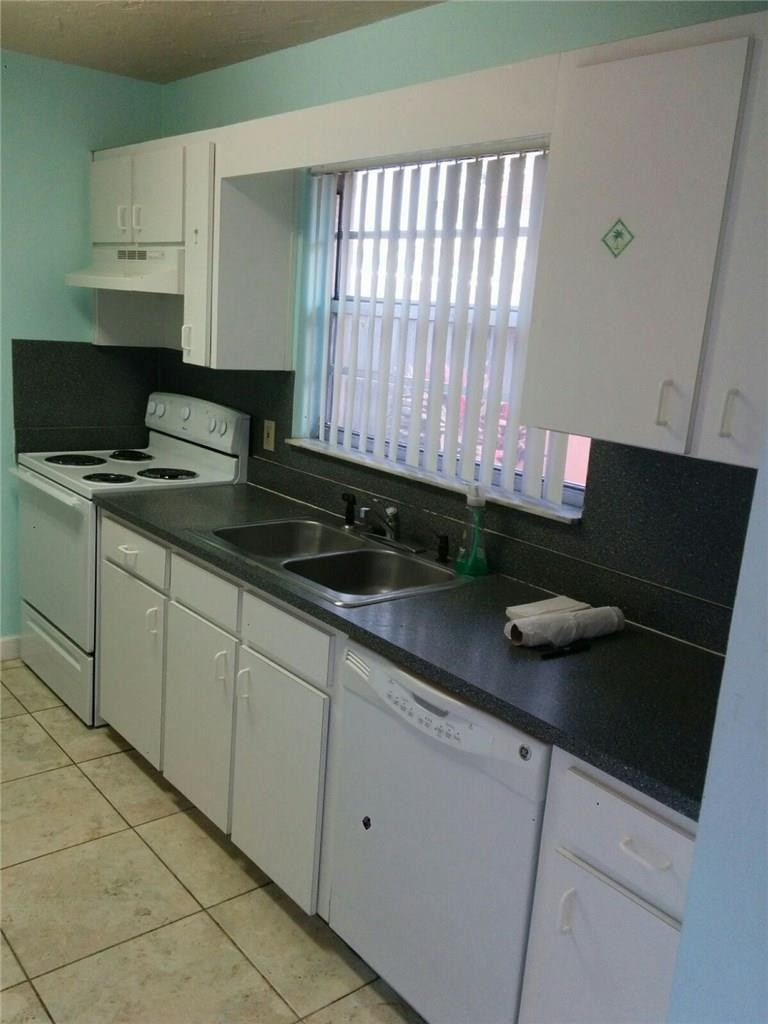 11229 Southwest 152nd Terrace Miami, FL 33157 - Photo 12 of 26 a kitchen with stainless steel appliances granite countertop a sink stove and cabinets