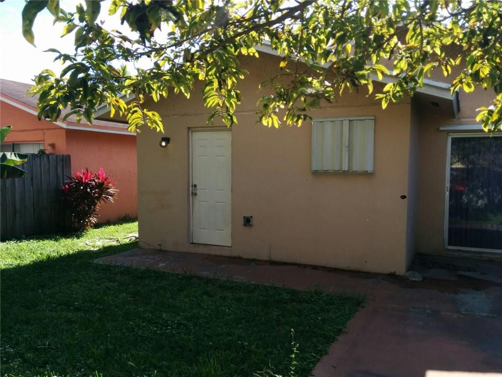 11229 Southwest 152nd Terrace Miami, FL 33157 - Photo 17 of 26 a view of backyard with potted plants and a large tree