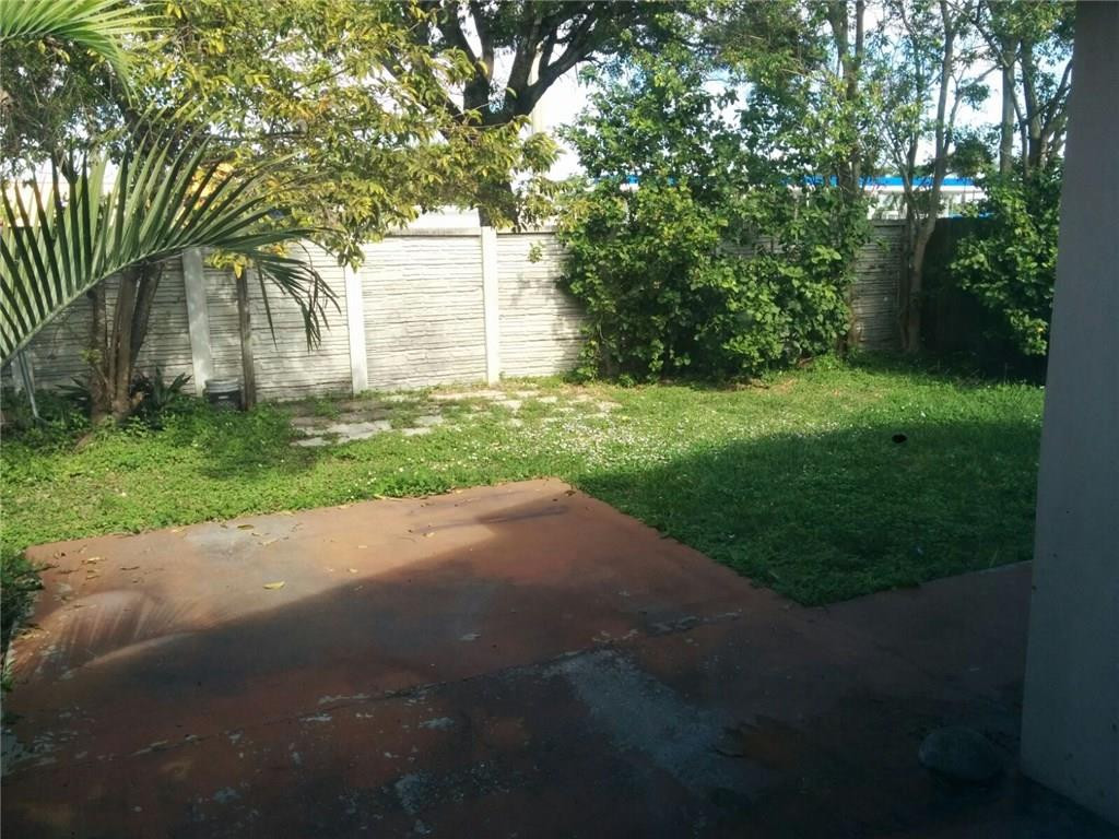 11229 Southwest 152nd Terrace Miami, FL 33157 - Photo 18 of 26 a backyard of a house with plants and large trees