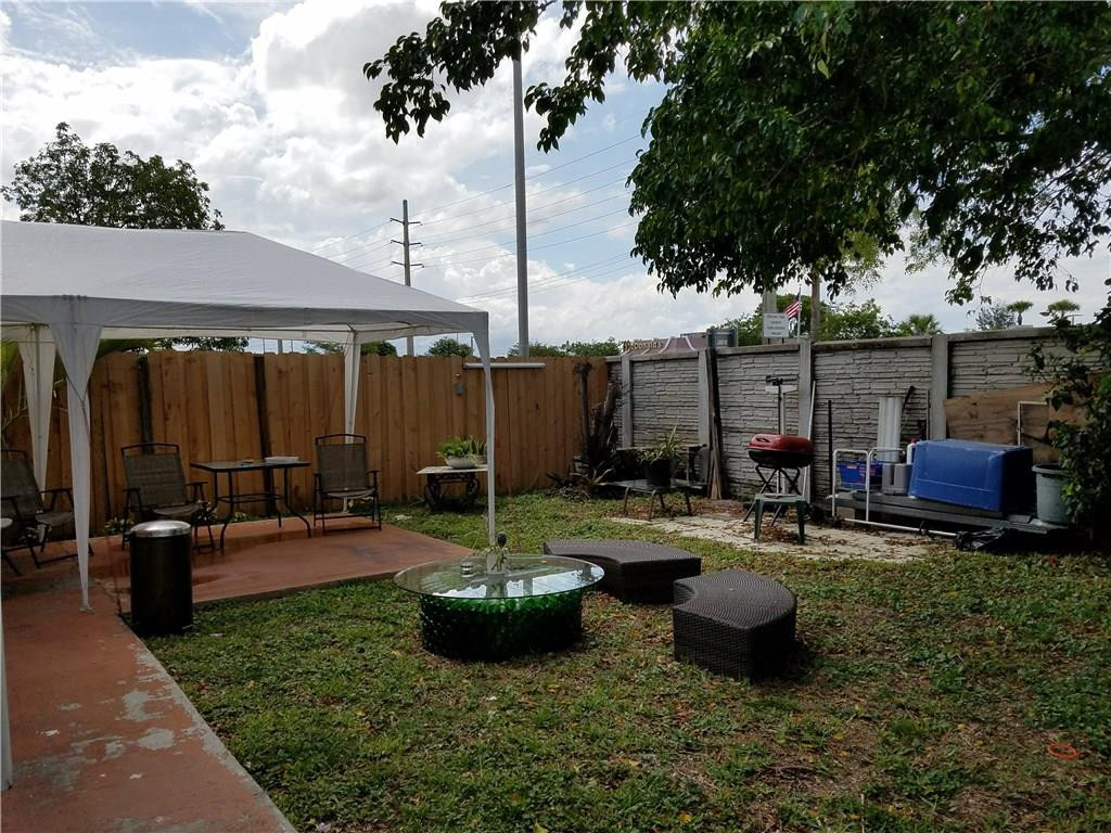 11229 Southwest 152nd Terrace Miami, FL 33157 - Photo 20 of 26 a view of a patio with couches chairs and a fire pit