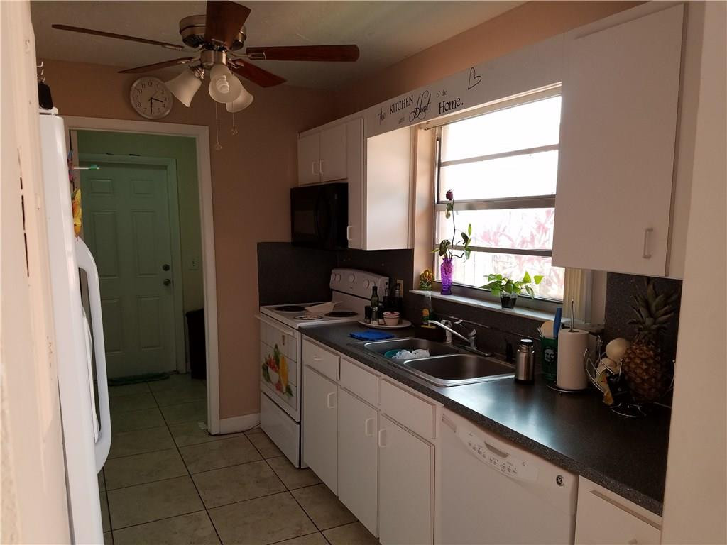 11229 Southwest 152nd Terrace Miami, FL 33157 - Photo 23 of 26 a kitchen with a sink appliances and a window