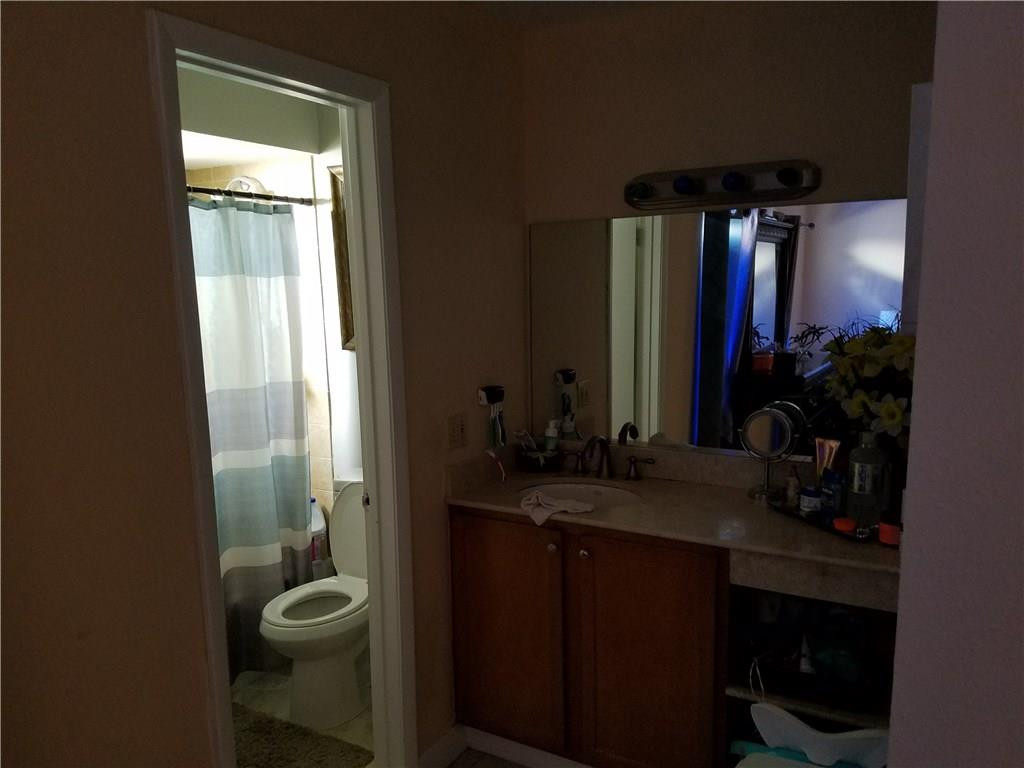 11229 Southwest 152nd Terrace Miami, FL 33157 - Photo 24 of 26 a bathroom with a granite countertop sink toilet and shower
