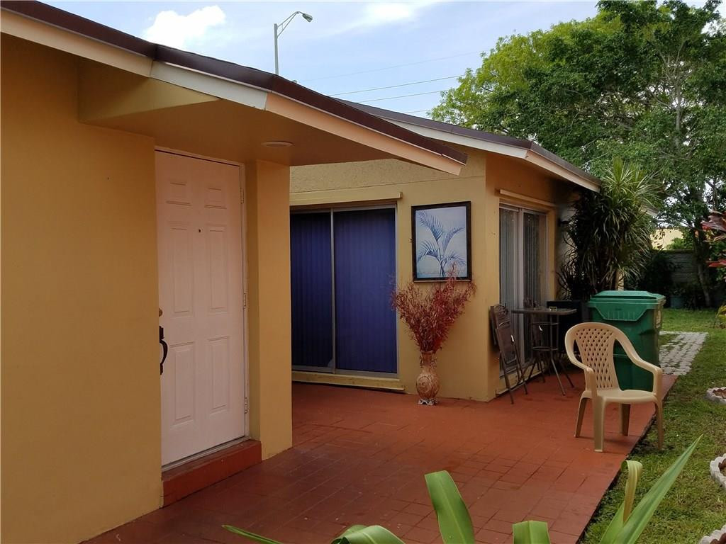 11229 Southwest 152nd Terrace Miami, FL 33157 - Photo 4 of 26 a backyard of a house with seating space