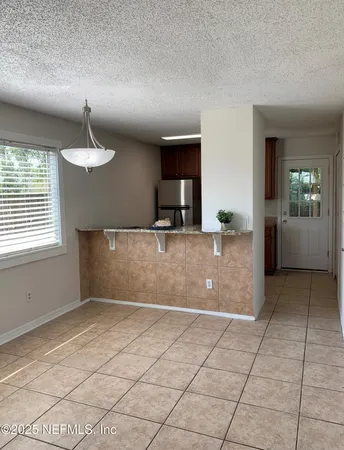 a view of a kitchen with kitchen island a sink wooden floor and a window